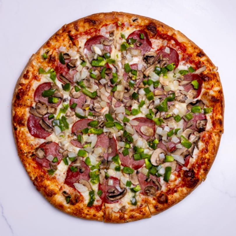 Whole pepperoni pizza with green peppers, onions, and mushrooms on a white background.